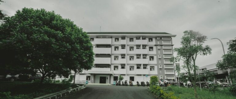 a large white building sitting on the side of a road