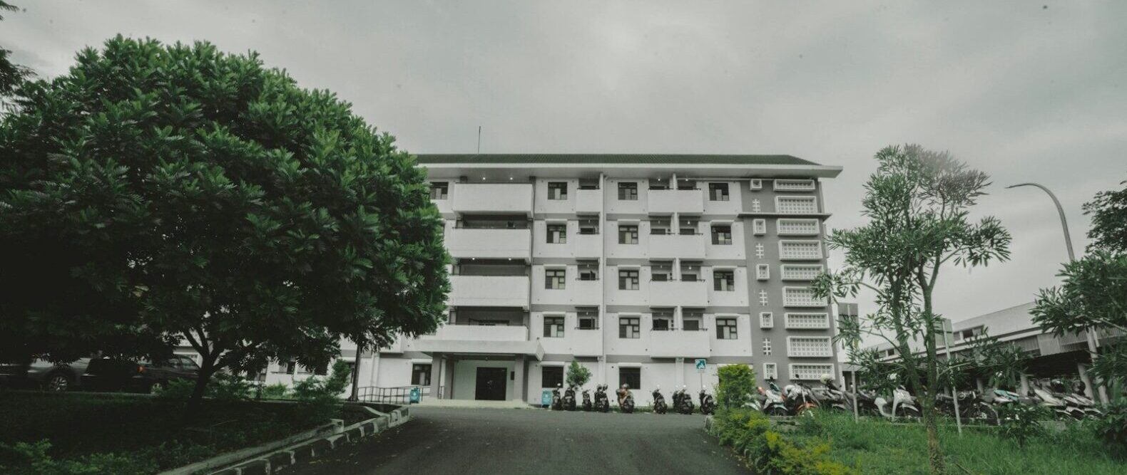 a large white building sitting on the side of a road